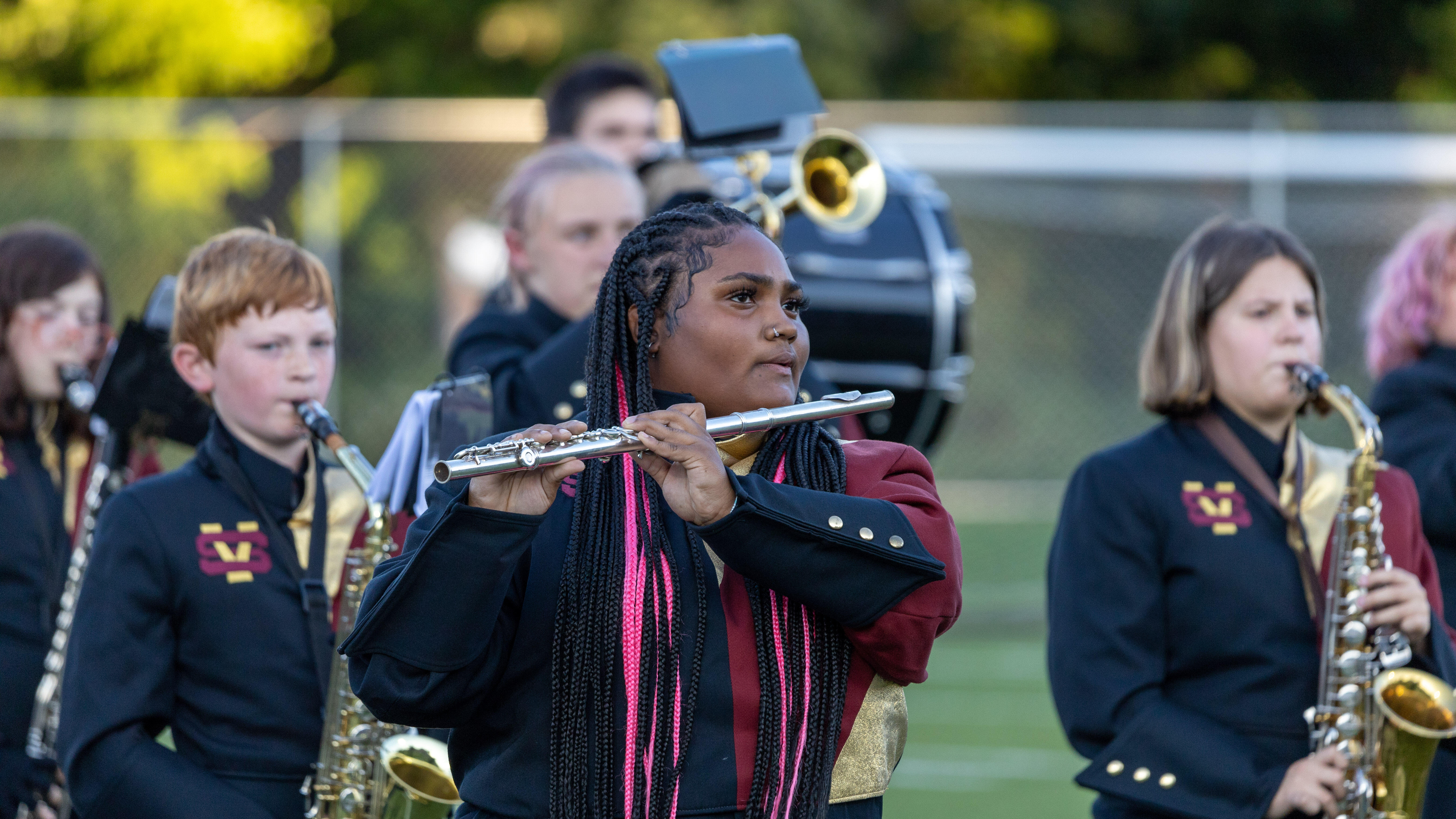 The Steel Valley Marching Band performs during halftime of a football game. 