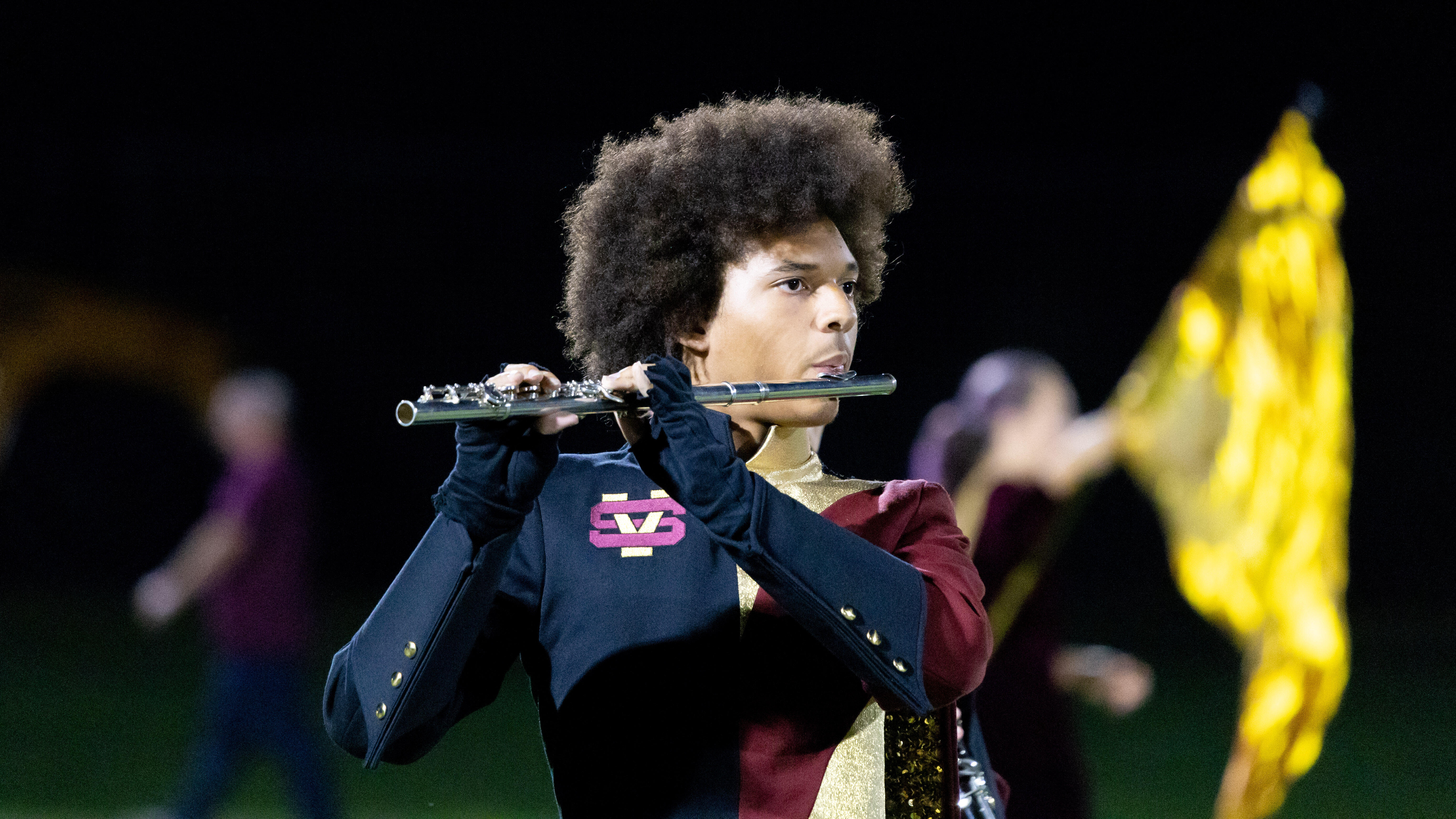 The Steel Valley Marching Band performs during halftime of a football game. Flute player Atreyu Convard is in the foreground.