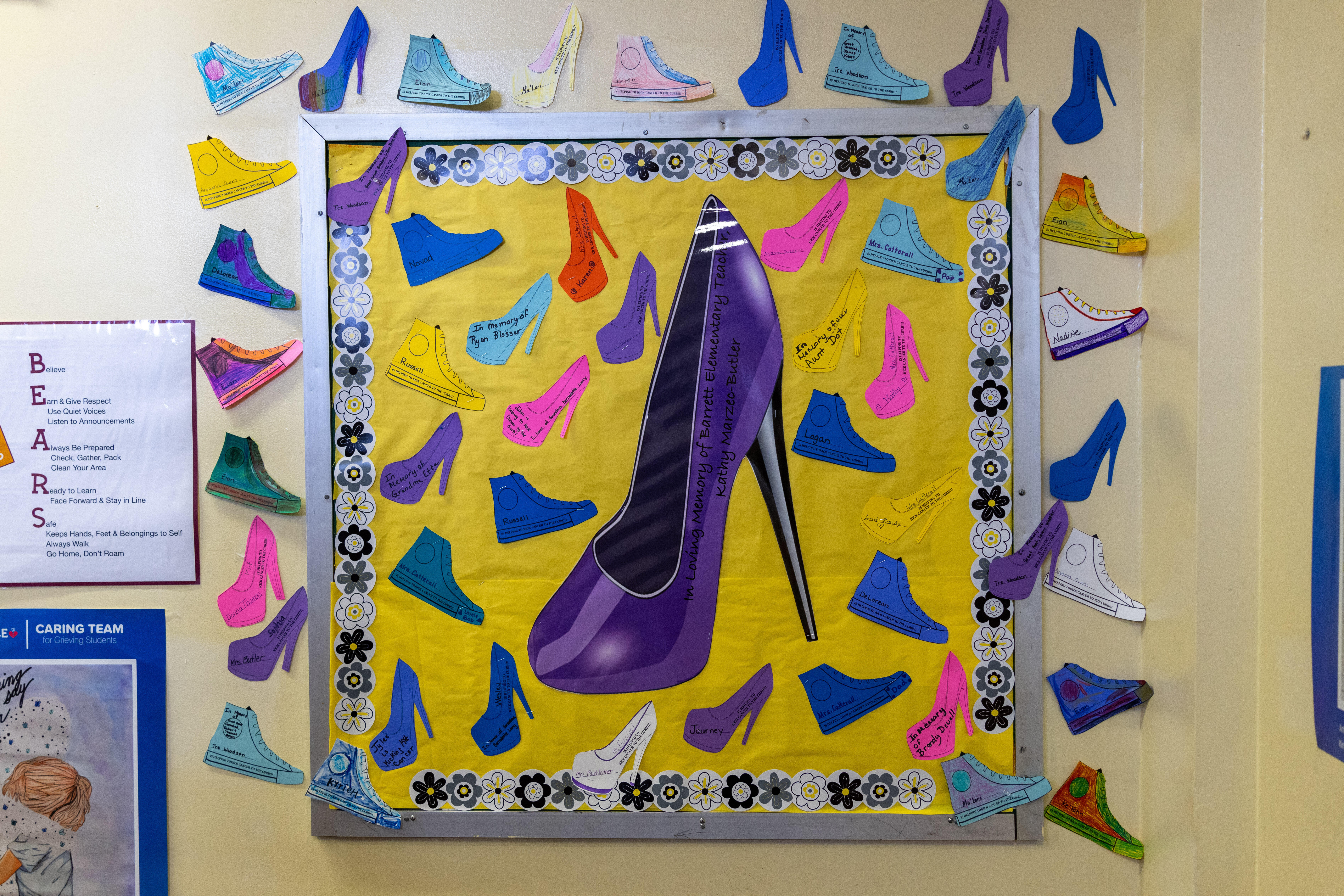 A photo depicting a large shoe cutout on a wall that served as a donation drive