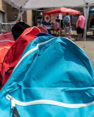 Colorful bookbags sit on a table at the Salvation Army Steel Valley Corps' Back to School Backpack Bash