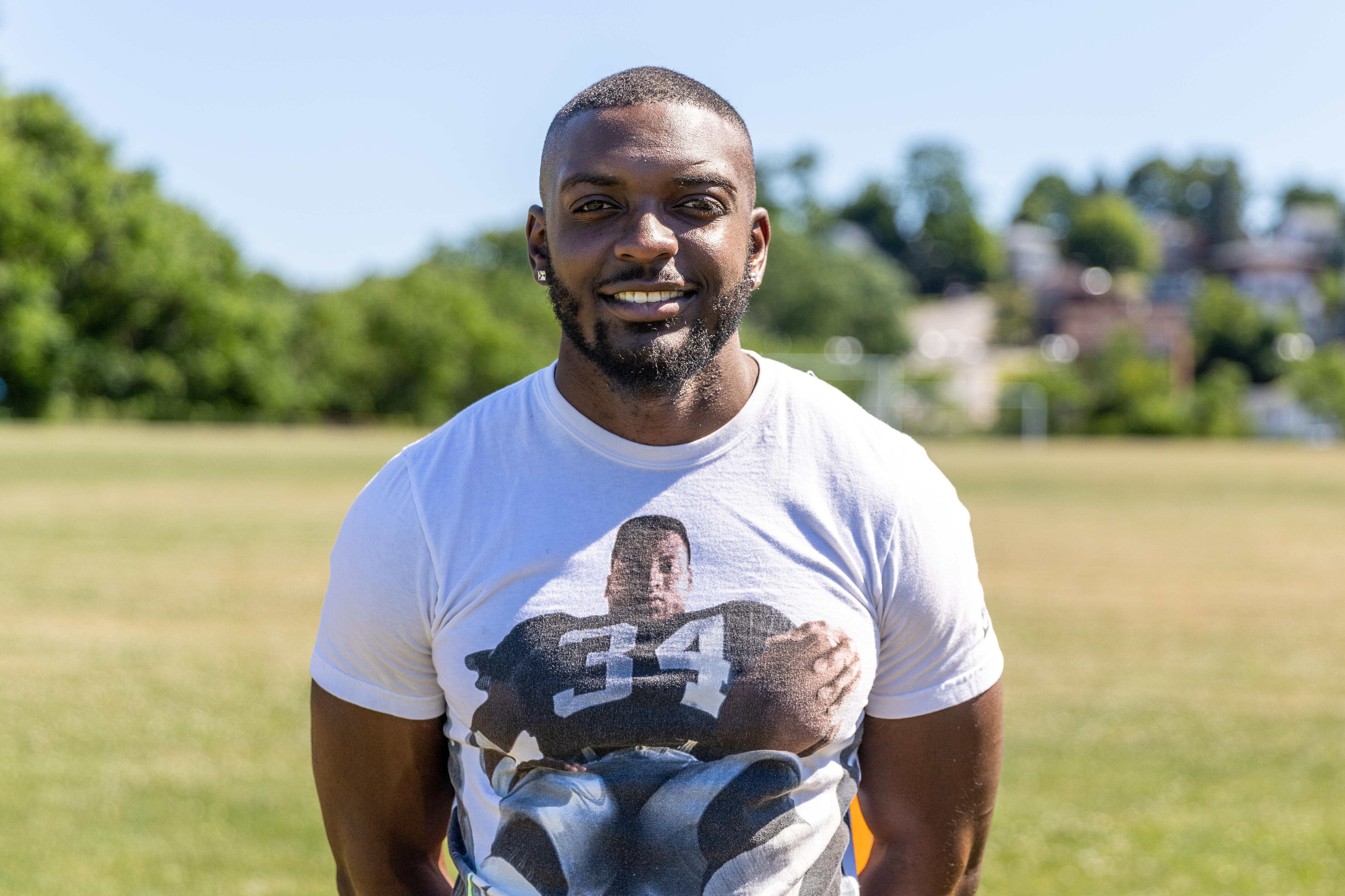 Steel Valley Middle School football coach Dontez Williams poses on the team practice field.