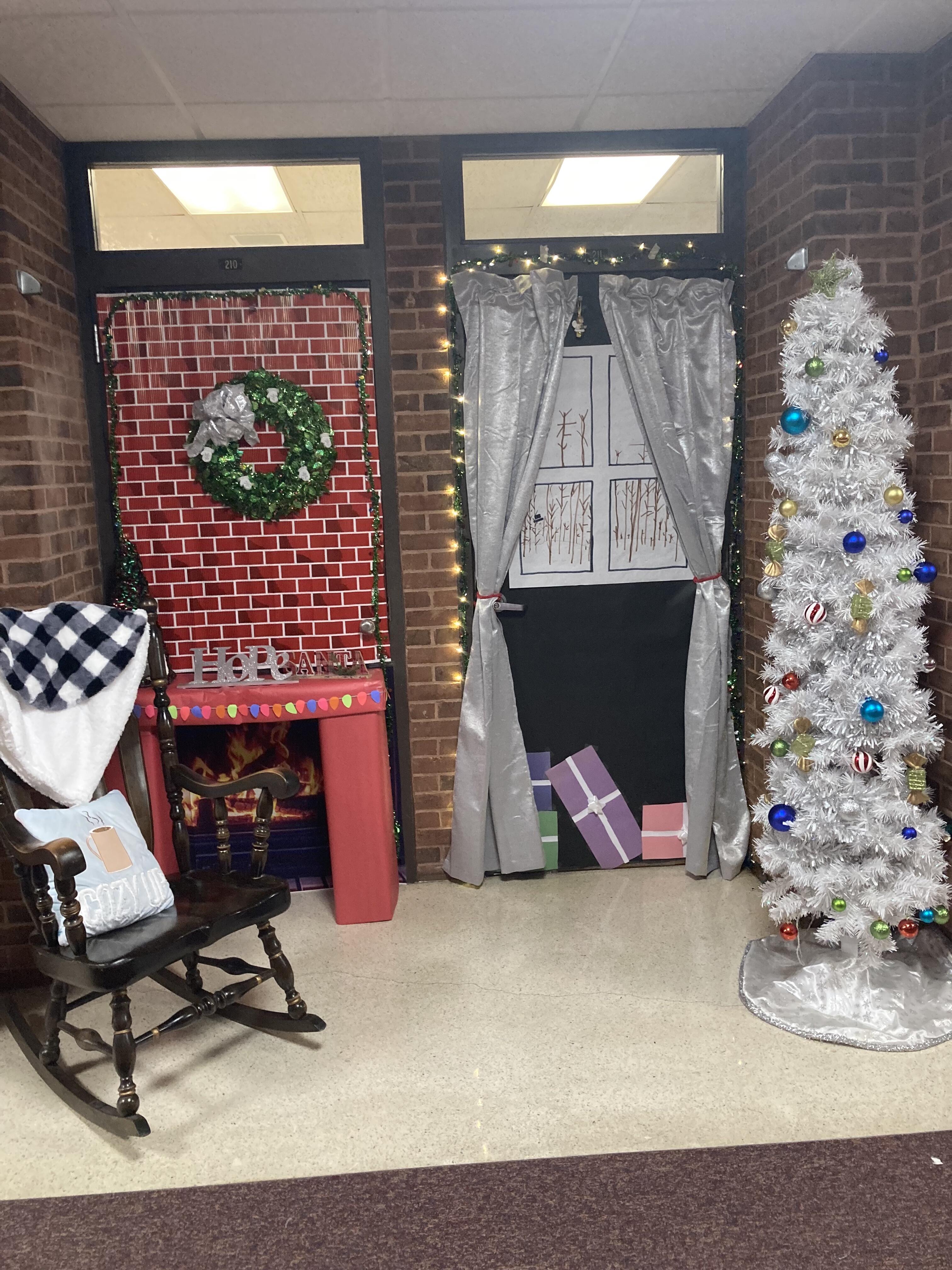 Two classroom doors are decorated to celebrate the holiday season. One is made to look like a Christmas present, while the other has a winter theme.