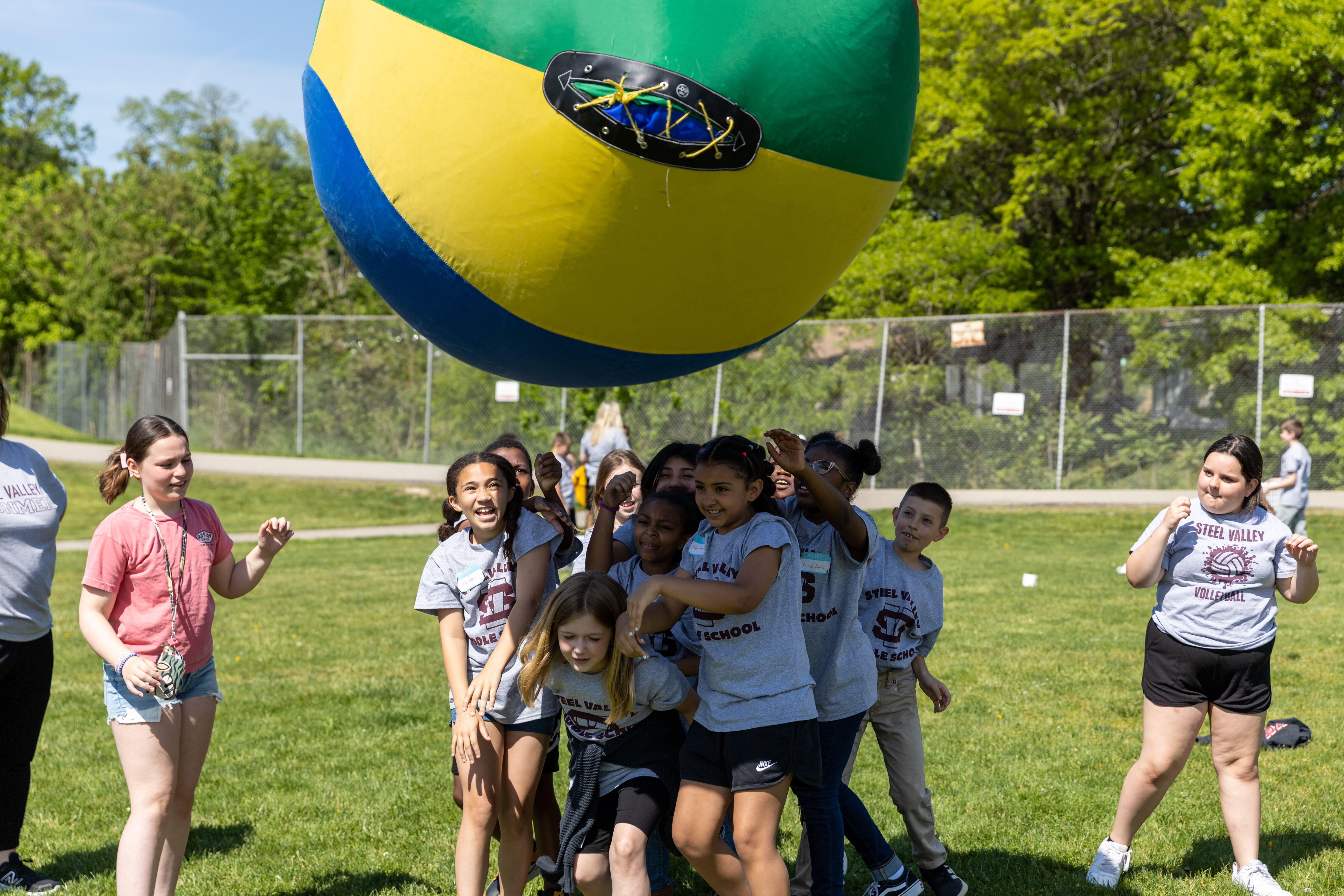 Students work together to throw a massive inflated ball