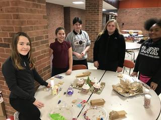 More students are working on another gingerbread house