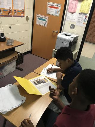 Two students working and discussing