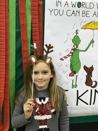 Student posing with Grinch display