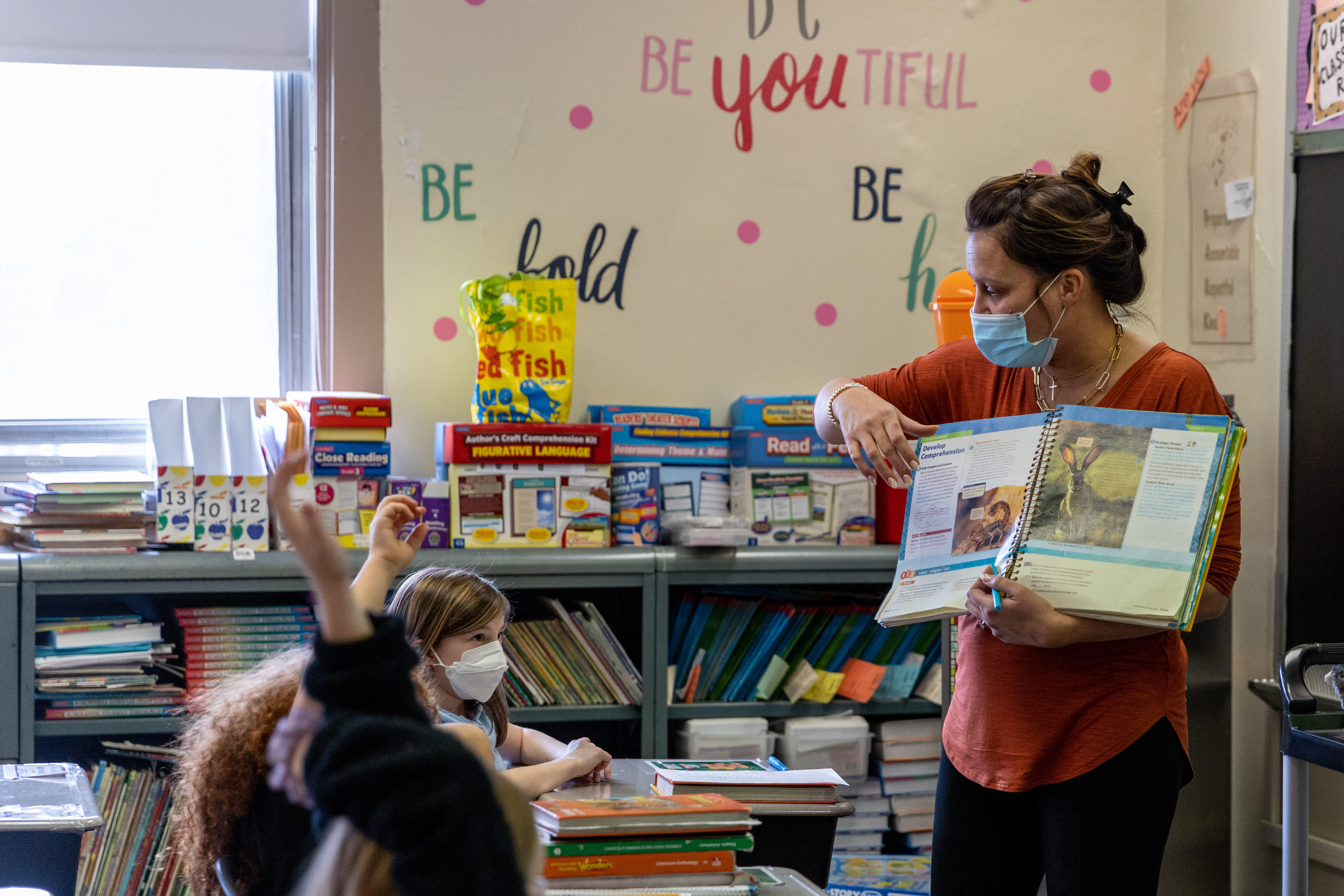 An elementary teacher reads to students